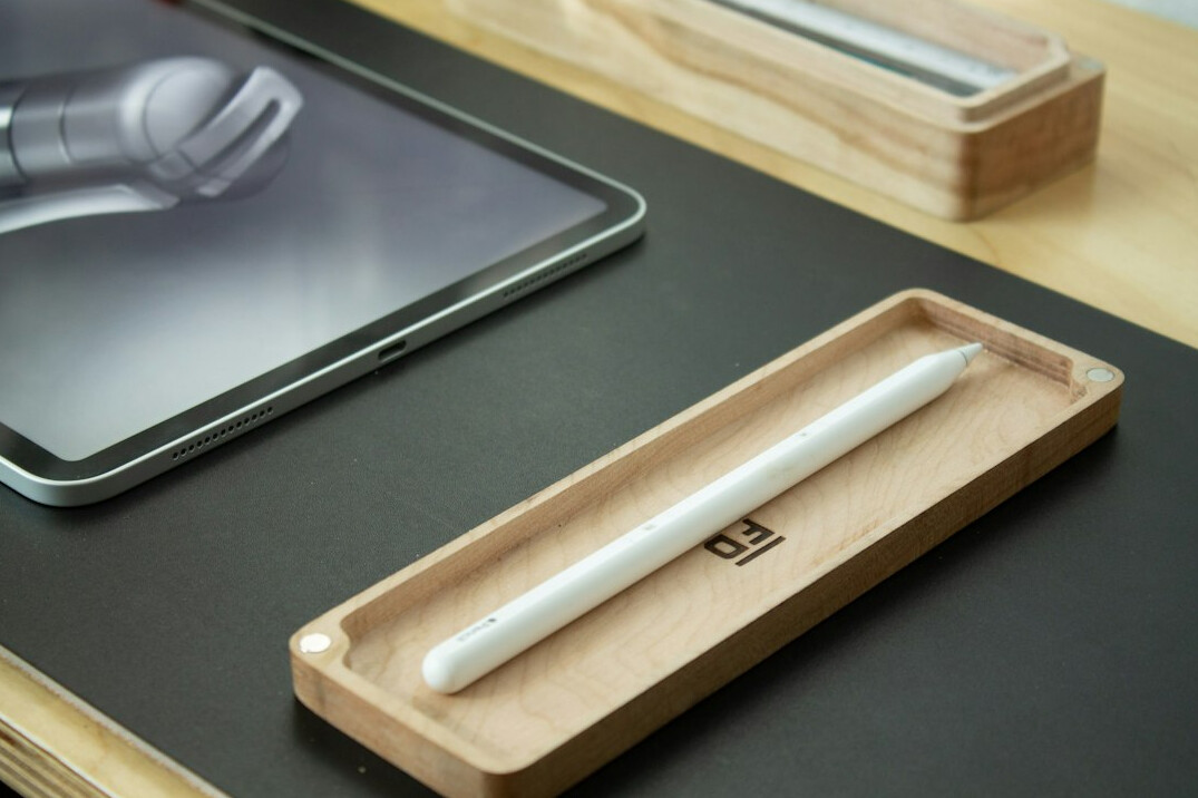 Open notebook and pen on a wooden desk with soft natural light