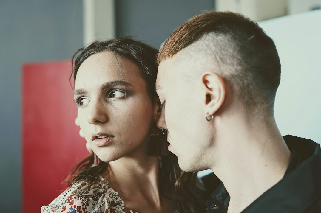 Two Brazilian colleagues having an attentive conversation at a table