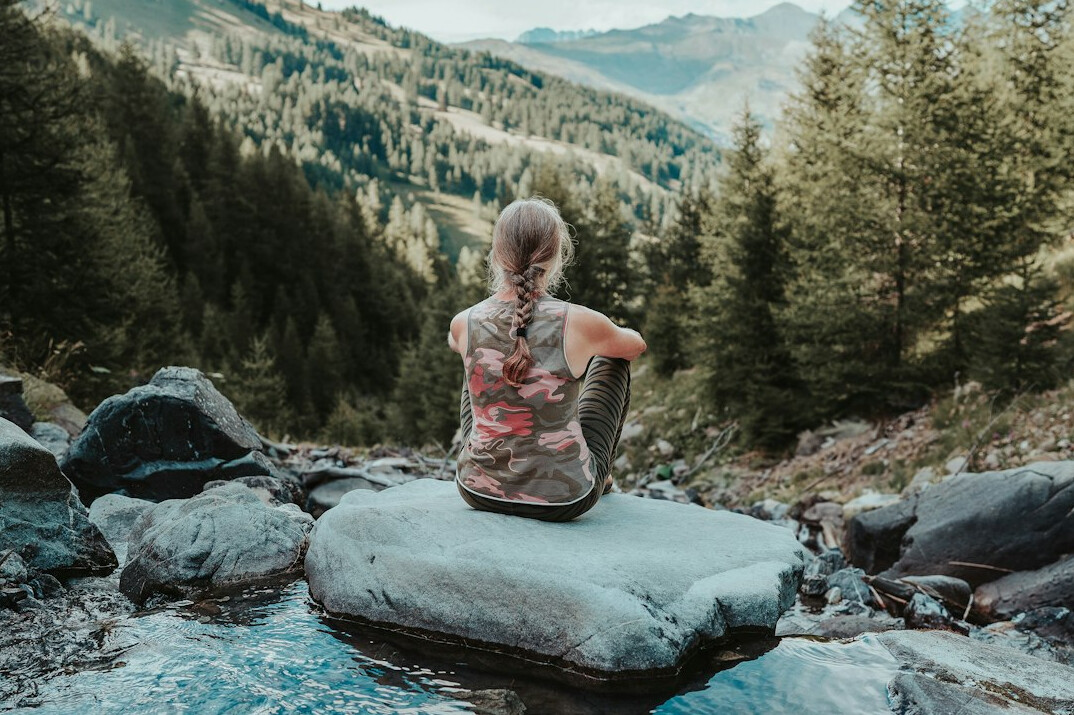 person meditating in nature
