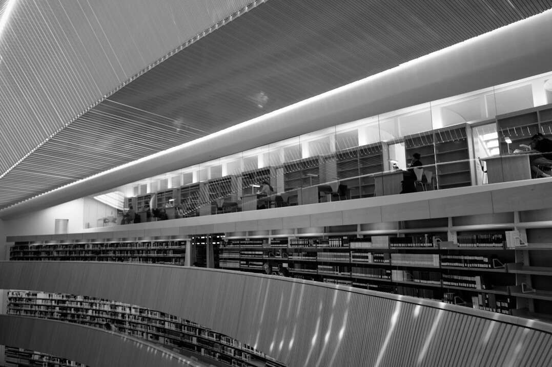 person reading book at desk