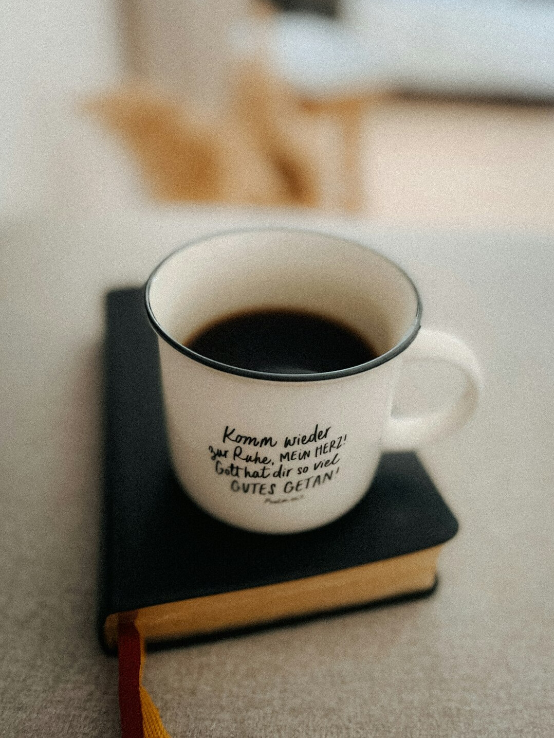 Stack of books and a cup of coffee on a reading table